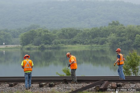 A couple workers manually remove the tie plates. These will be reused when the new ties are inserted.