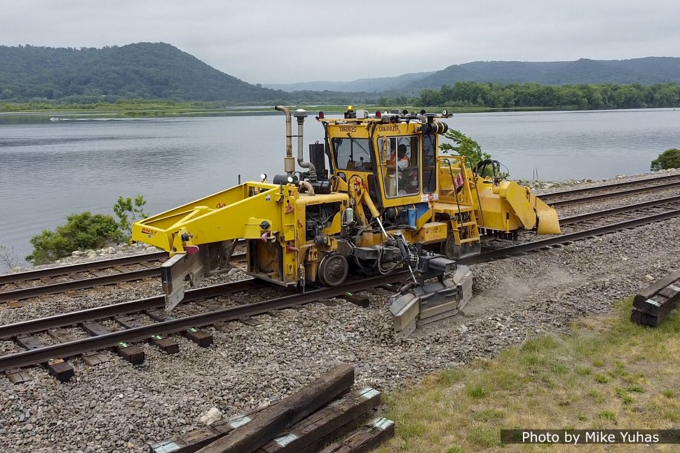 The ballast regulator seen in this photo pulls the ballast shoulder up in the area disturbed by the tie installation.